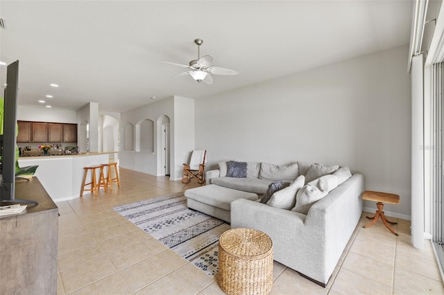 living area with arched walkways, ceiling fan, light tile patterned floors, recessed lighting, and visible vents