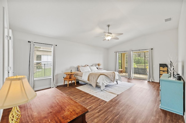 bedroom with dark wood-style floors, multiple windows, visible vents, and access to exterior