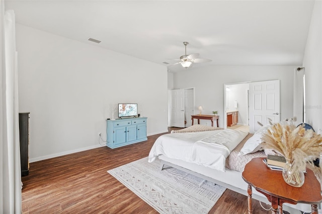 bedroom with ceiling fan, wood finished floors, visible vents, baseboards, and vaulted ceiling