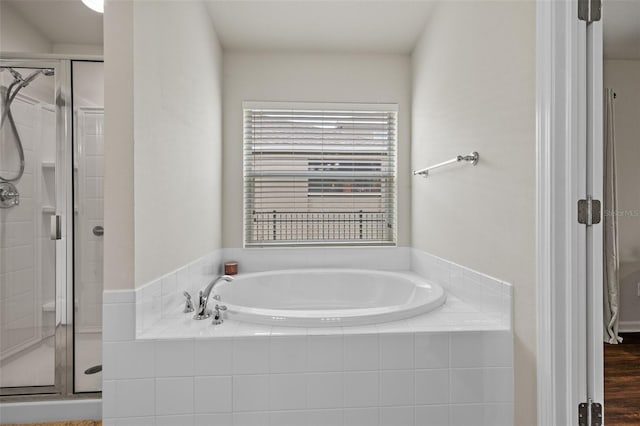 bathroom featuring a garden tub and a stall shower