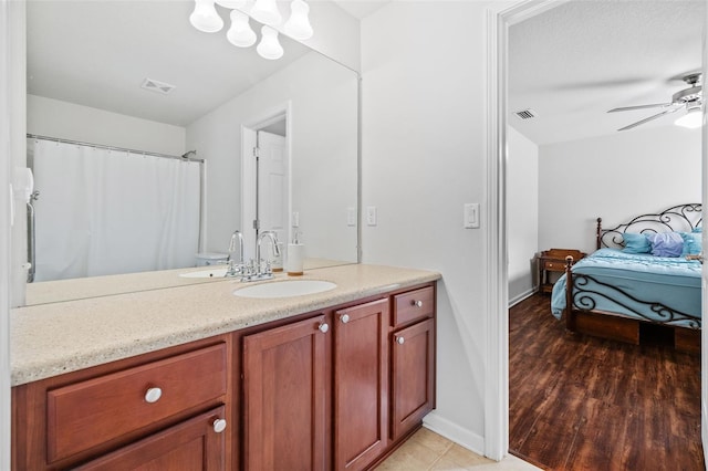 ensuite bathroom featuring ensuite bath, visible vents, a ceiling fan, and vanity