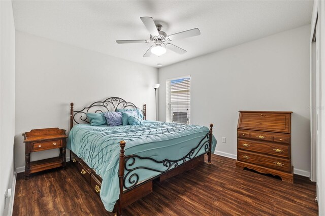 bedroom with wood finished floors, a ceiling fan, and baseboards