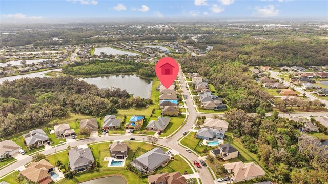 drone / aerial view with a water view and a residential view