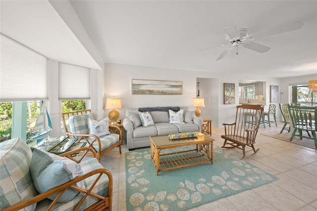 tiled living area with a ceiling fan