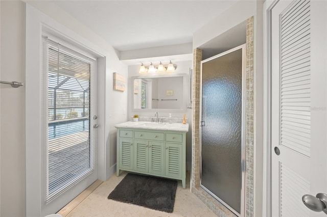 bathroom with a shower stall and vanity