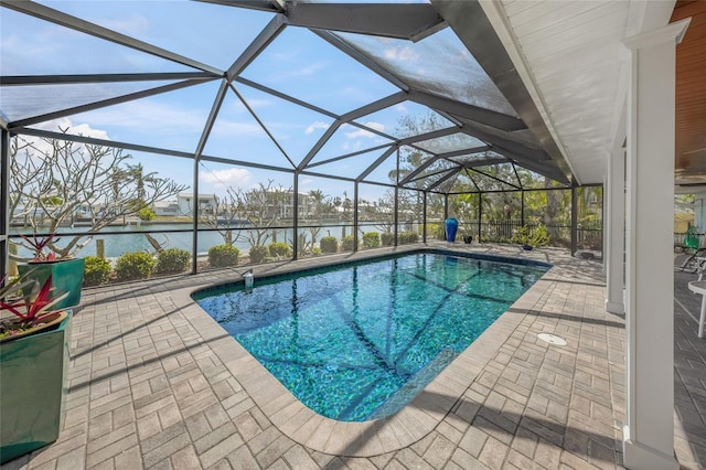 pool featuring a patio area, glass enclosure, and a water view