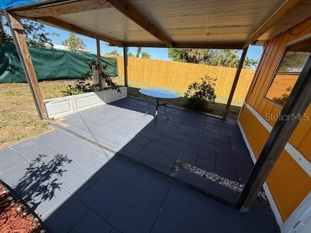 view of patio / terrace featuring fence