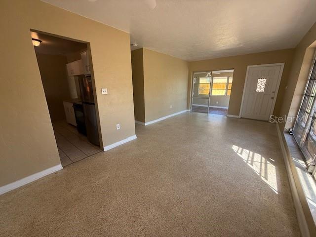 spare room with speckled floor and baseboards