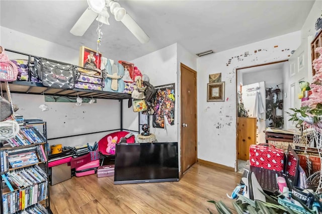 bedroom with ceiling fan, visible vents, and wood finished floors