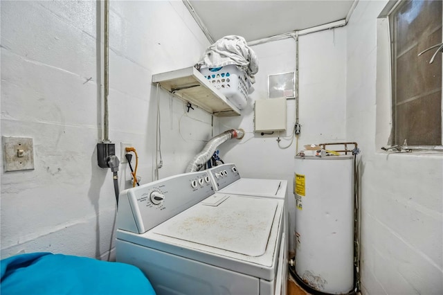 laundry area with gas water heater, washing machine and clothes dryer, and laundry area