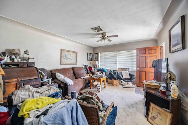 carpeted living room with ceiling fan and visible vents