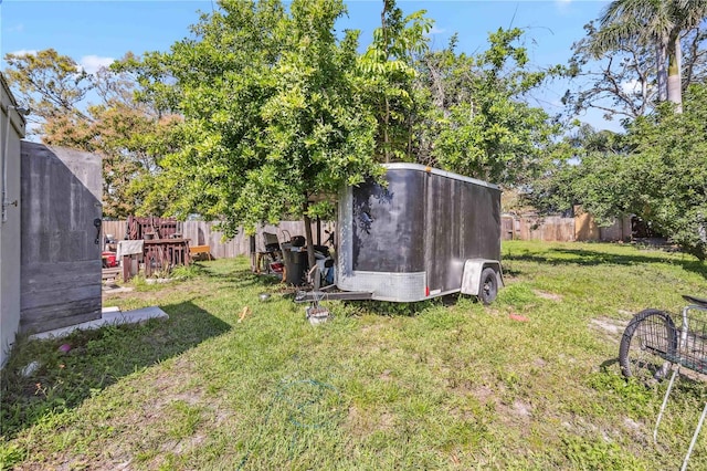 view of yard featuring a fenced backyard and an outbuilding