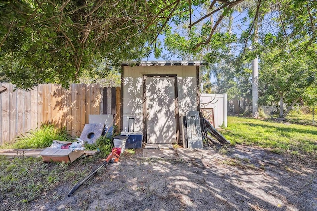 view of shed featuring fence