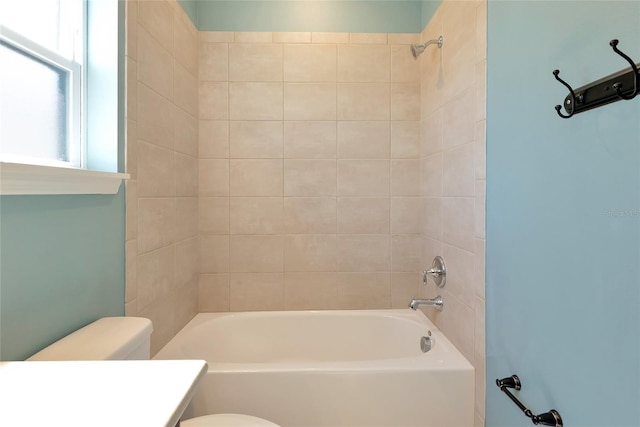 bathroom featuring toilet, vanity, and washtub / shower combination