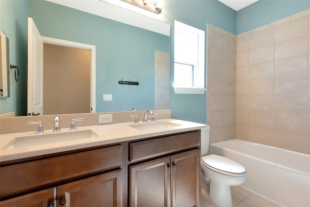 full bathroom featuring double vanity, tile patterned flooring, toilet, and a sink