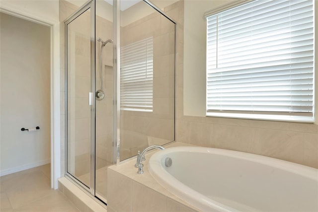 bathroom with a garden tub, a stall shower, and tile patterned flooring