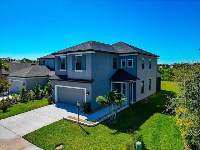 view of front of property featuring a front yard, an attached garage, concrete driveway, and stucco siding