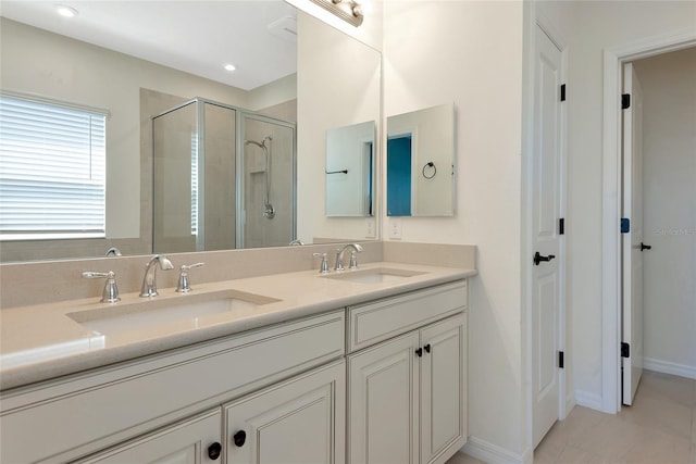 full bath featuring a shower stall, recessed lighting, double vanity, and a sink