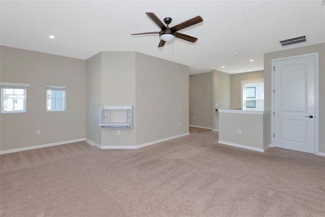 spare room featuring recessed lighting, visible vents, baseboards, and light carpet