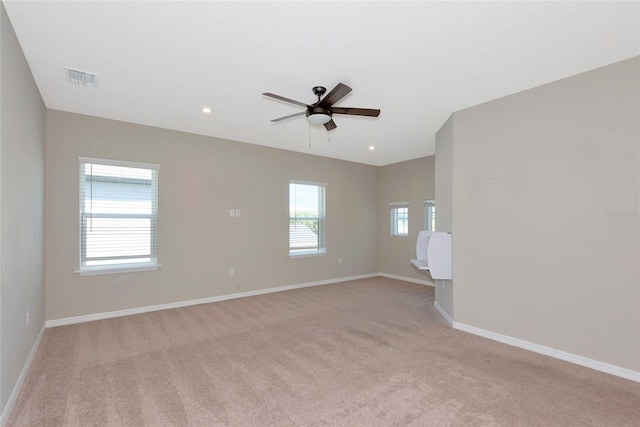 unfurnished room with a ceiling fan, baseboards, visible vents, recessed lighting, and light colored carpet