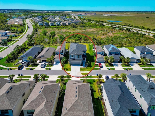 birds eye view of property with a residential view