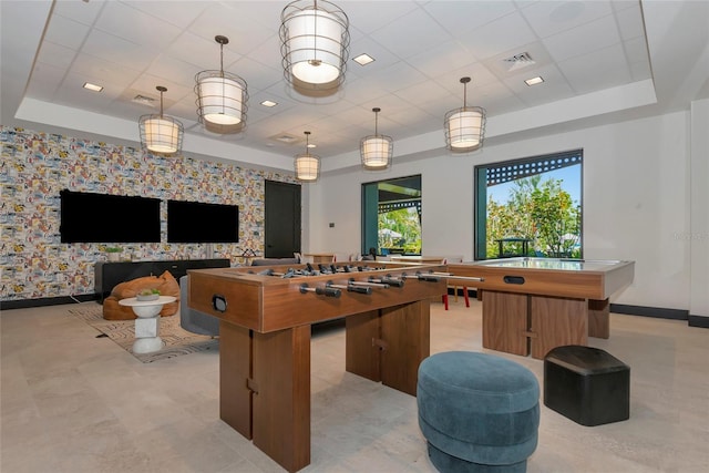 playroom with a raised ceiling, visible vents, baseboards, and a paneled ceiling