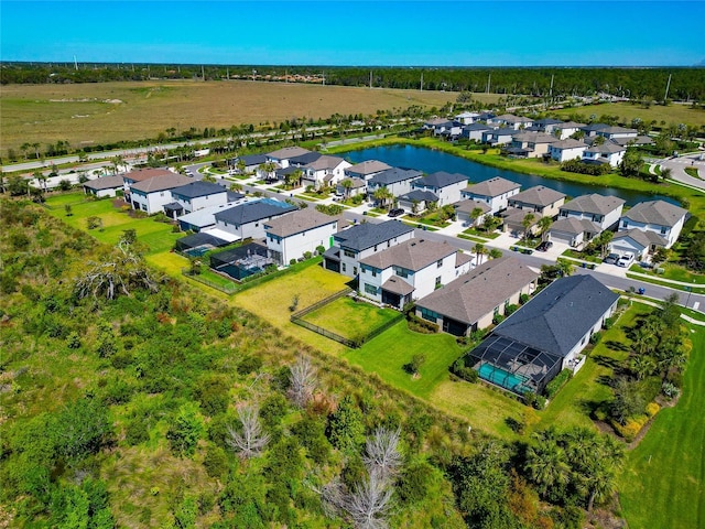 drone / aerial view with a residential view and a water view