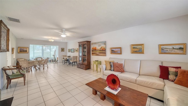 living area with visible vents, light tile patterned flooring, and a ceiling fan