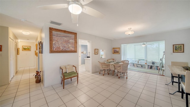 dining space featuring light tile patterned floors, a ceiling fan, and visible vents