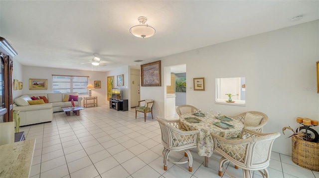 dining space with light tile patterned flooring and ceiling fan