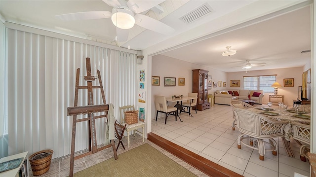 dining room with light tile patterned floors, visible vents, and ceiling fan