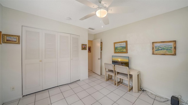 office area with light tile patterned flooring, visible vents, and ceiling fan