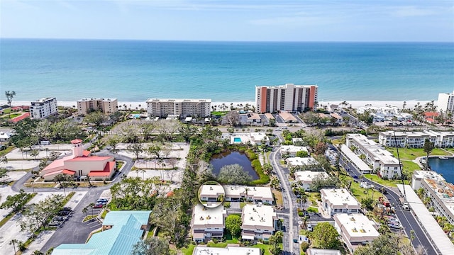 birds eye view of property featuring a water view and a view of city