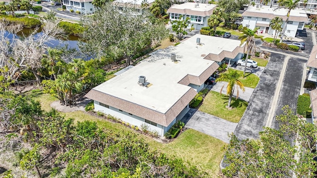 drone / aerial view featuring a residential view and a water view