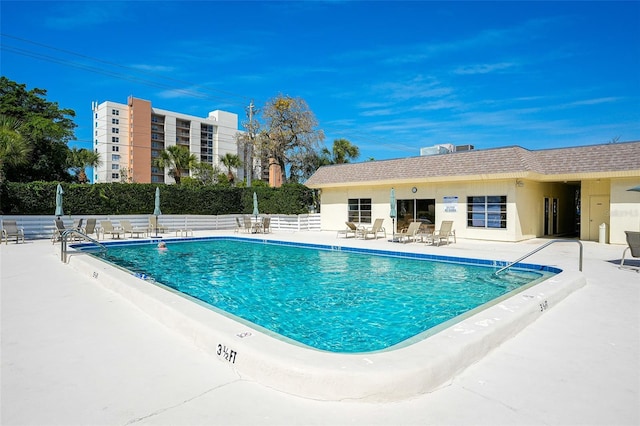 pool featuring a patio area and fence