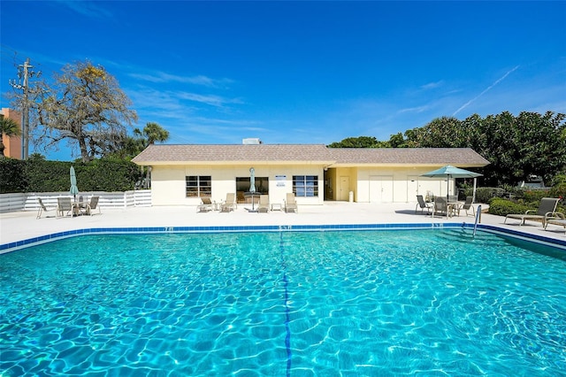 community pool featuring a patio and fence