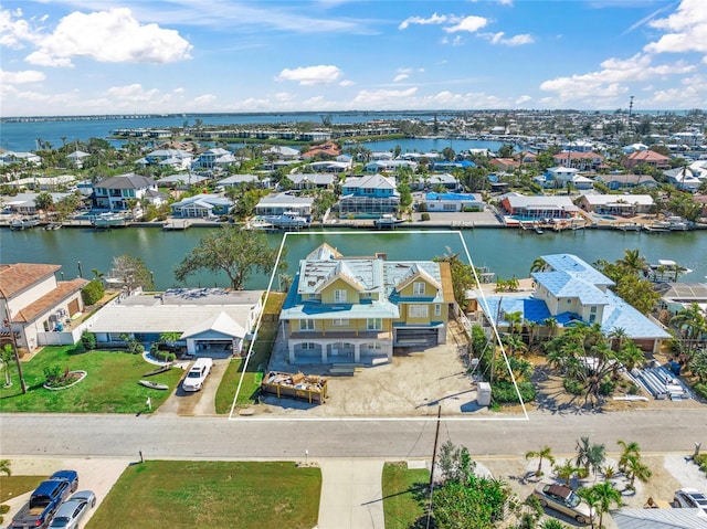 drone / aerial view featuring a residential view and a water view