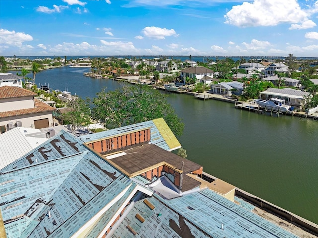 drone / aerial view featuring a residential view and a water view