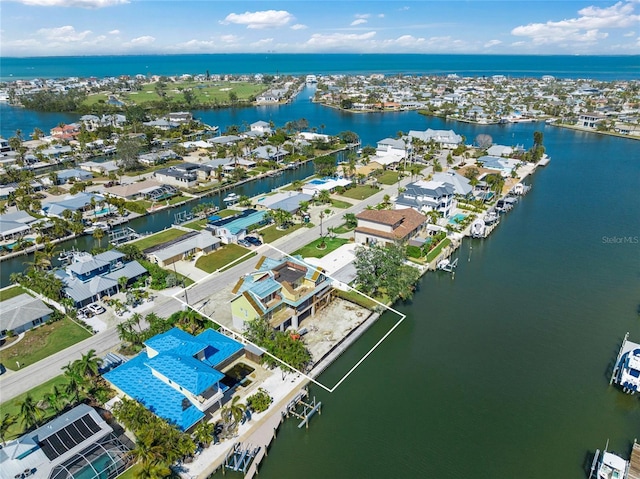 drone / aerial view with a residential view and a water view