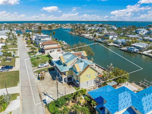 birds eye view of property with a water view and a residential view