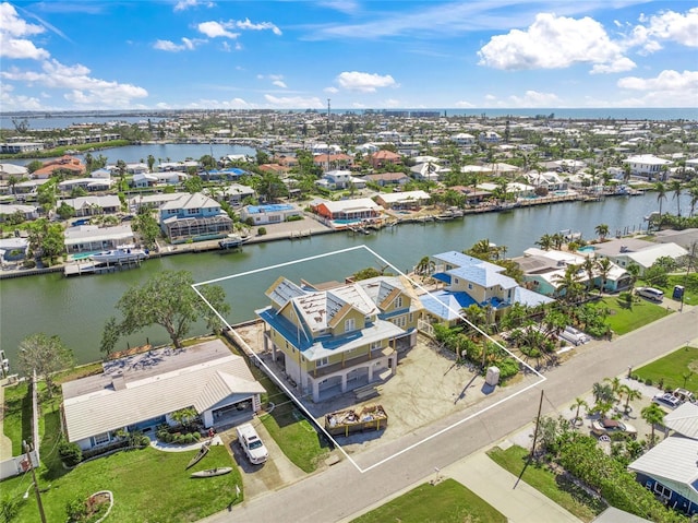 drone / aerial view featuring a water view and a residential view