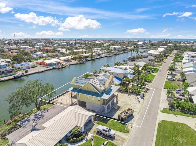 birds eye view of property featuring a residential view and a water view