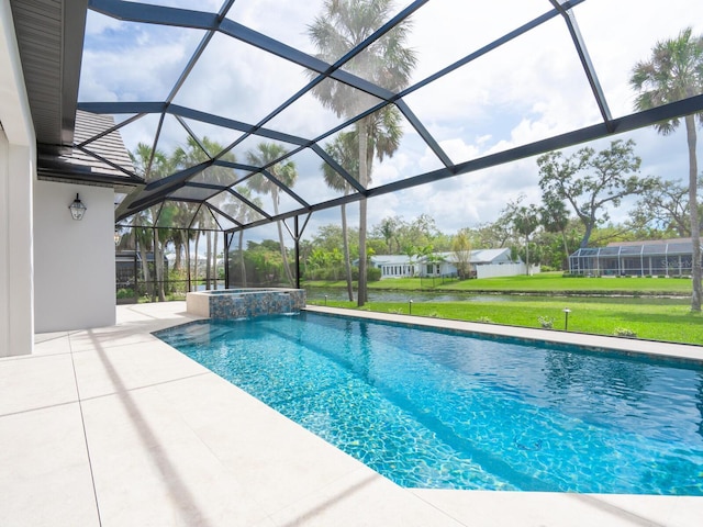 view of pool featuring a lanai, a yard, a pool with connected hot tub, and a patio