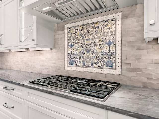 kitchen featuring white cabinetry, tasteful backsplash, and stainless steel gas cooktop