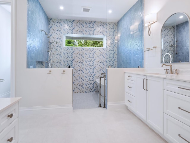 full bath featuring visible vents, walk in shower, vanity, and tile patterned flooring