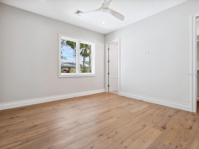 unfurnished room with visible vents, ceiling fan, light wood-type flooring, and baseboards