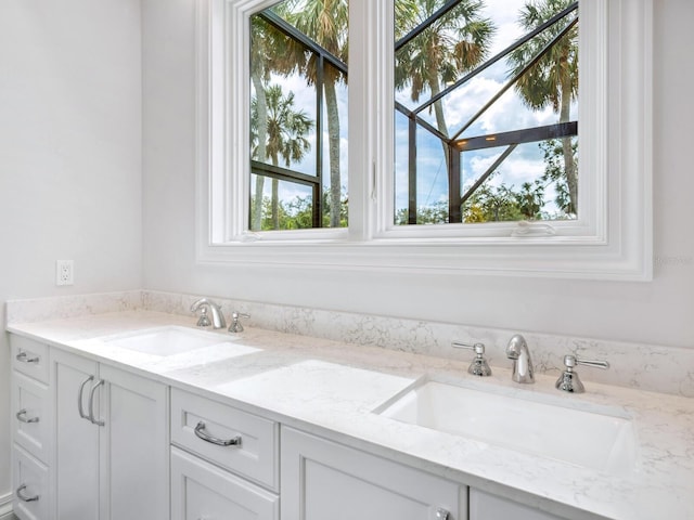 bathroom with a sink and double vanity