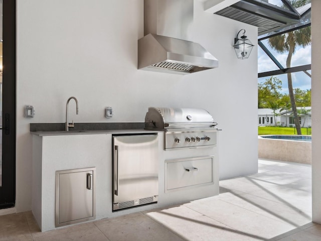 view of patio / terrace featuring a lanai, area for grilling, and a sink