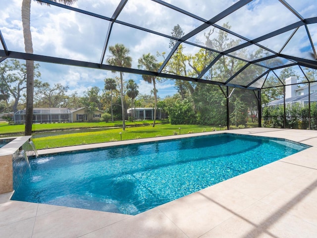 pool with a patio area, glass enclosure, and a yard