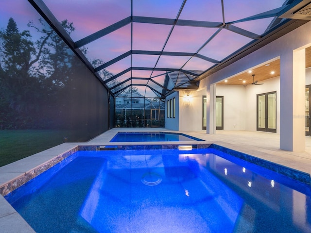 view of swimming pool featuring a lanai, french doors, a patio, and ceiling fan